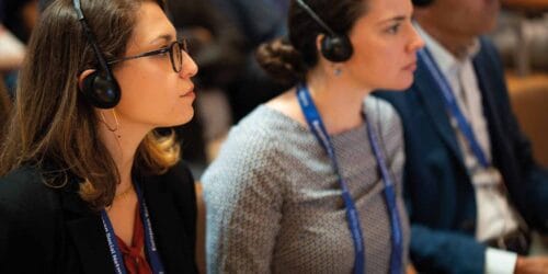 Conference attendees wearing translation headsets.