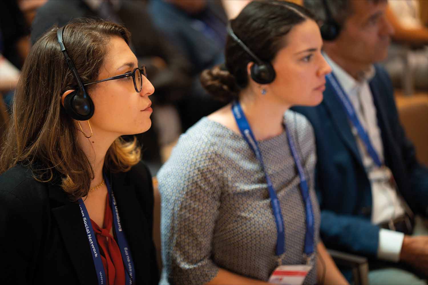 Conference attendees wearing translation headsets.